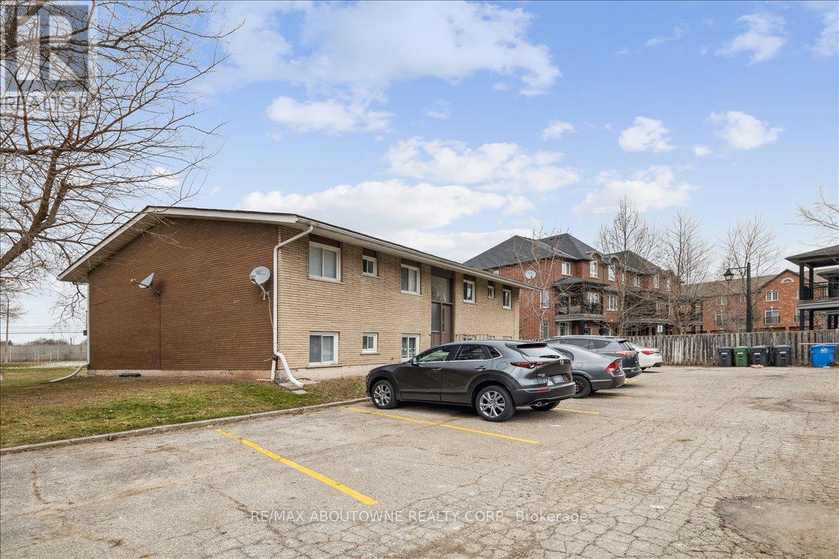 A parking lot with a building and cars parked in front.