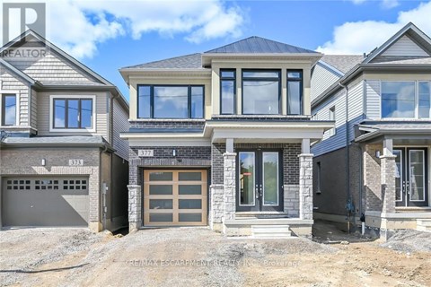 A row of houses with garages and the RE/MAX logo on the bottom left.