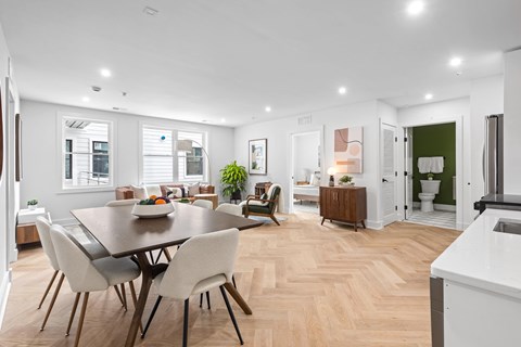 A modern dining room with a wooden table and chairs.