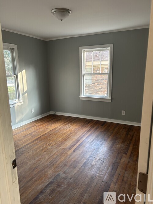 A room with wooden floors and a window.