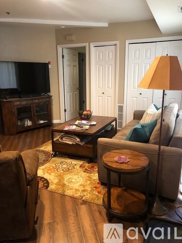A living room with a brown leather chair and a wooden coffee table.