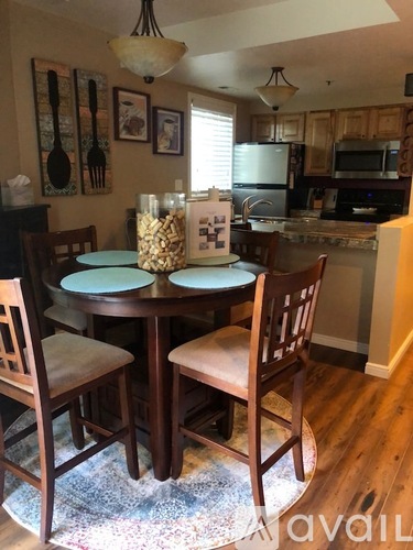 A kitchen with a table and chairs in the foreground.