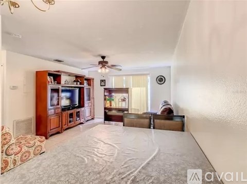 A living room with a television and a couch.