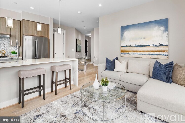 A modern living room with a large painting on the wall.