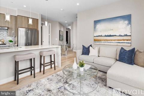 A modern living room with a large painting on the wall.