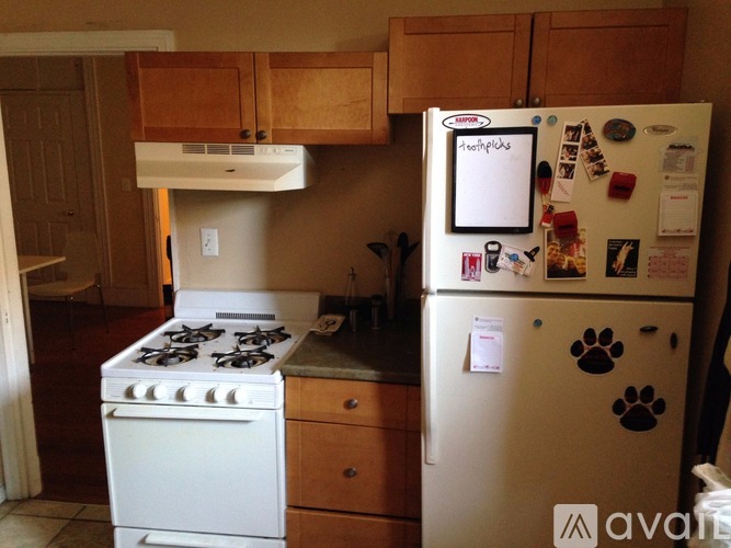 A white fridge with a paw print sticker on it.