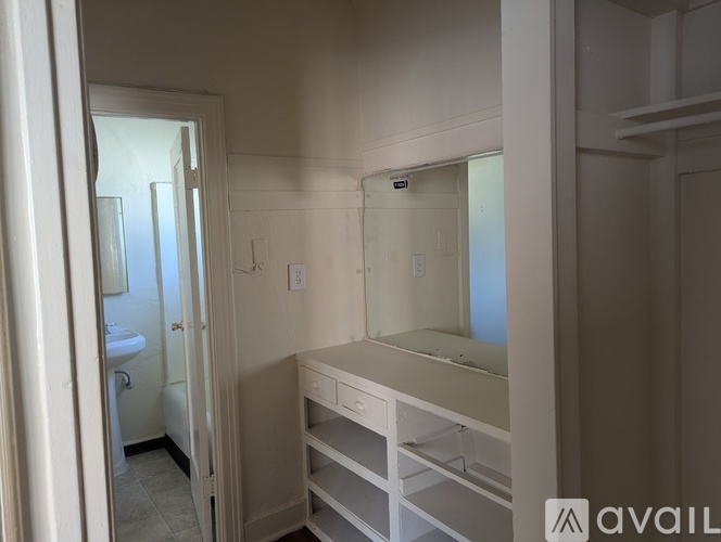 A bathroom with a sink, mirror, and a toilet.