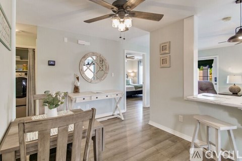A dining room with a wooden table and chairs.