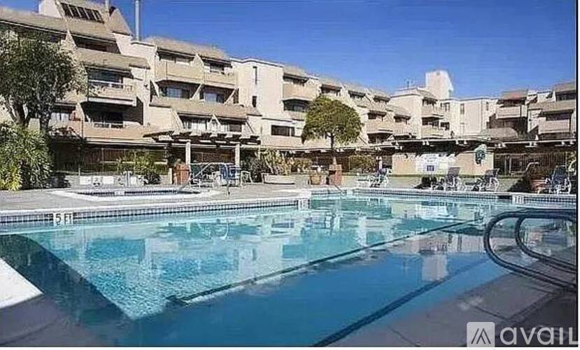 A swimming pool in front of apartment buildings.