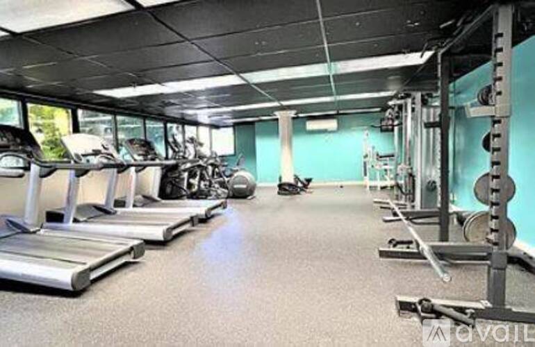 A gym with treadmills, weights, and exercise equipment.