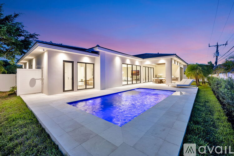 A modern house with a pool in the backyard.