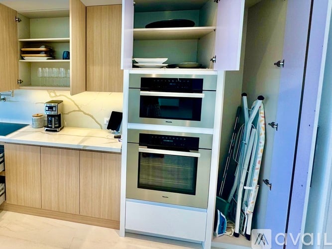 A modern kitchen with a white oven and wooden cabinets.