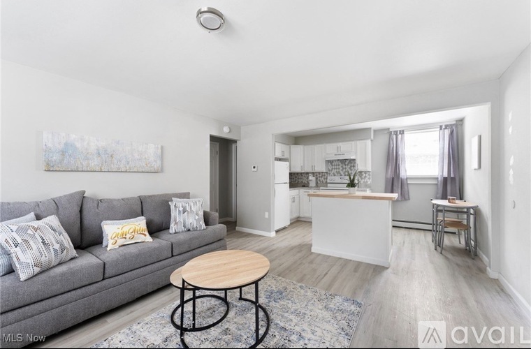 A living room with a grey couch and a wooden table.