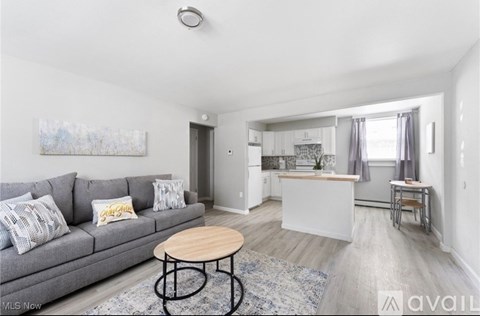 A living room with a grey couch and a wooden table.