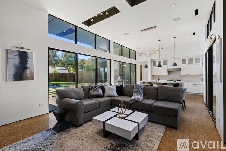 A modern living room with a grey sofa and a coffee table.