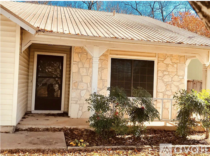 A house with a stone window and a door.