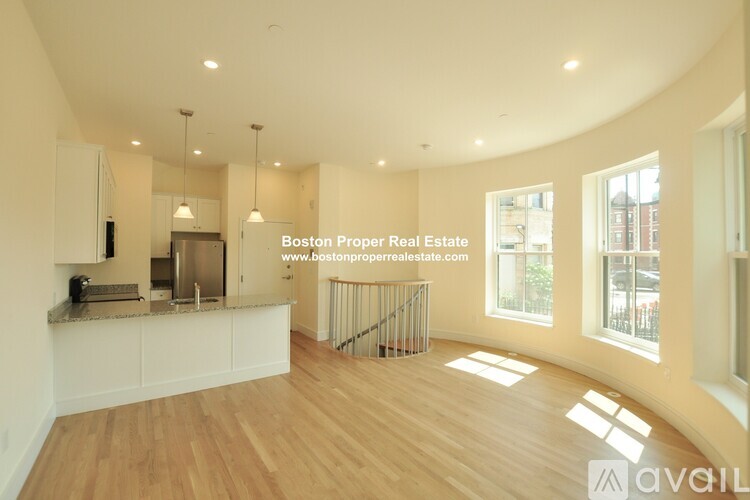 A spacious kitchen with wooden floors and a large island.