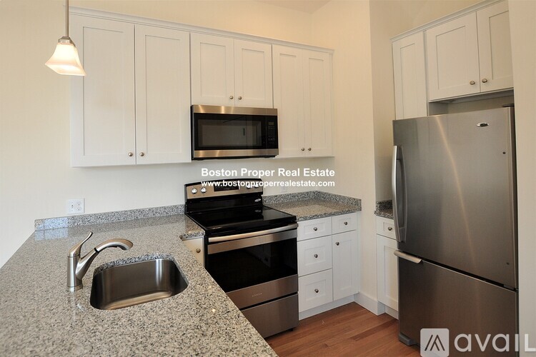 A kitchen with granite countertops and stainless steel appliances.