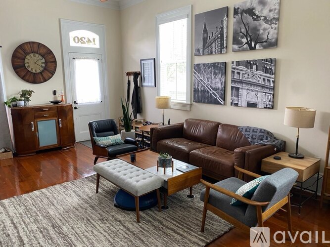 A living room with a brown leather couch and a wooden coffee table.