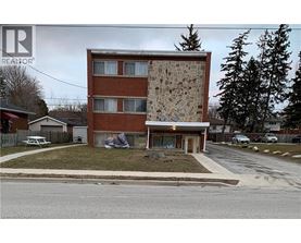A house with a stone wall on the side.