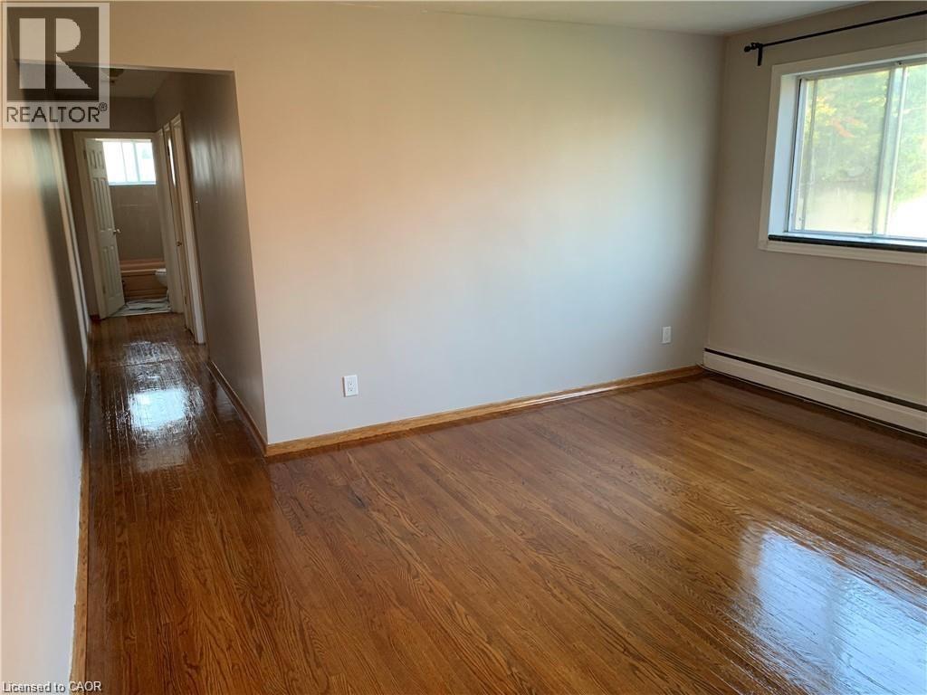 A room with wooden floors and a window.