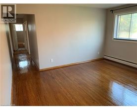 A room with wooden floors and a window.