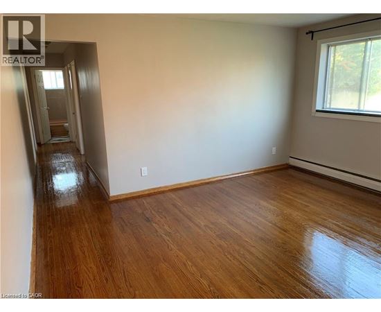 A room with wooden floors and a window.