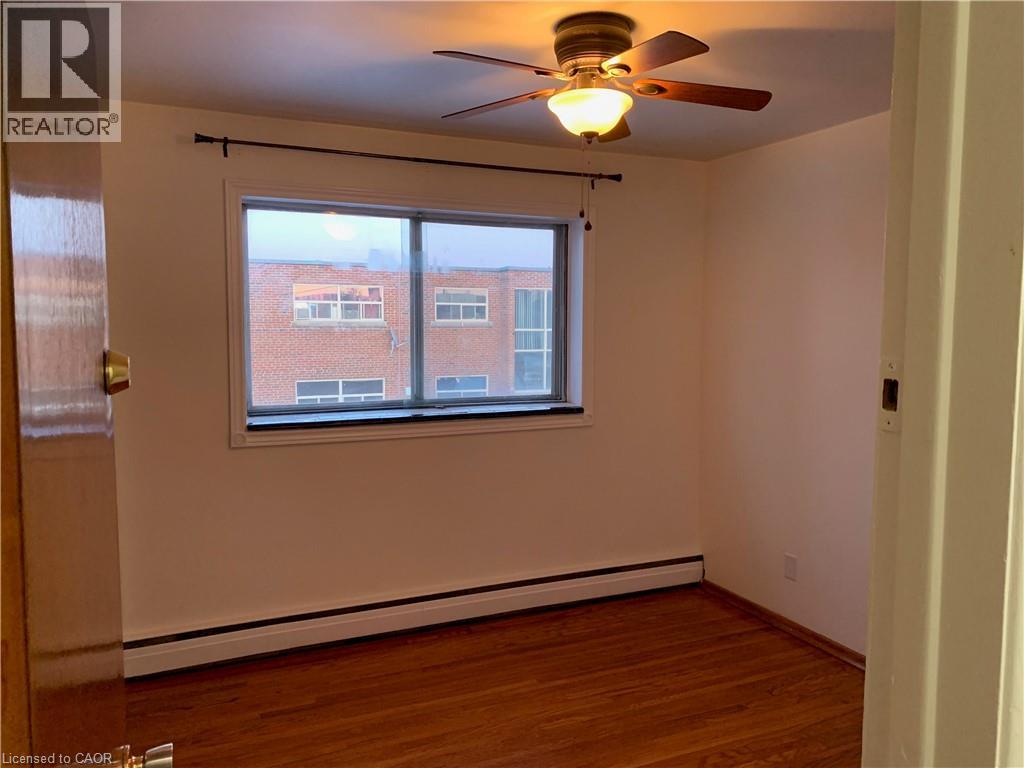 A room with a window and a ceiling fan.