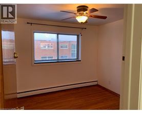 A room with a window and a ceiling fan.