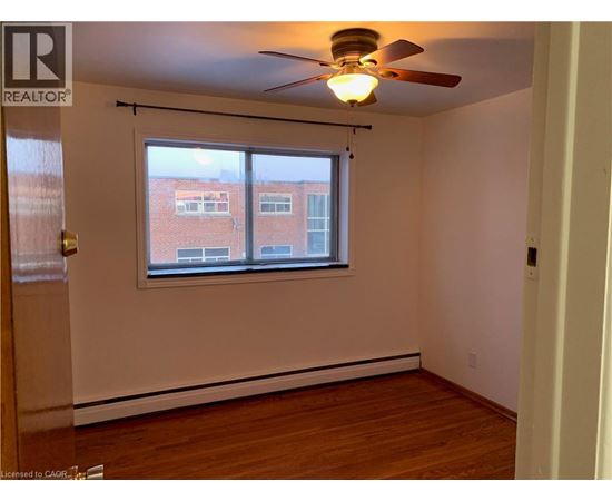 A room with a window and a ceiling fan.
