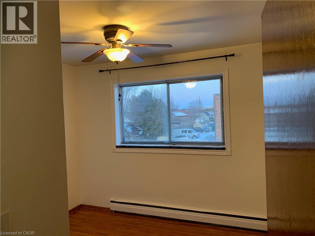 A room with a window and a ceiling fan.