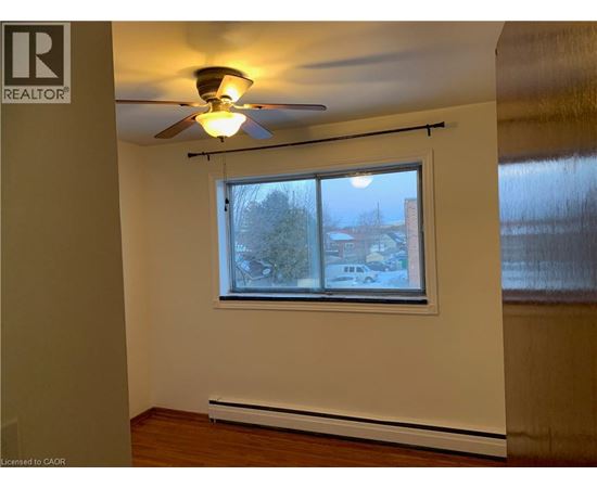 A room with a window and a ceiling fan.