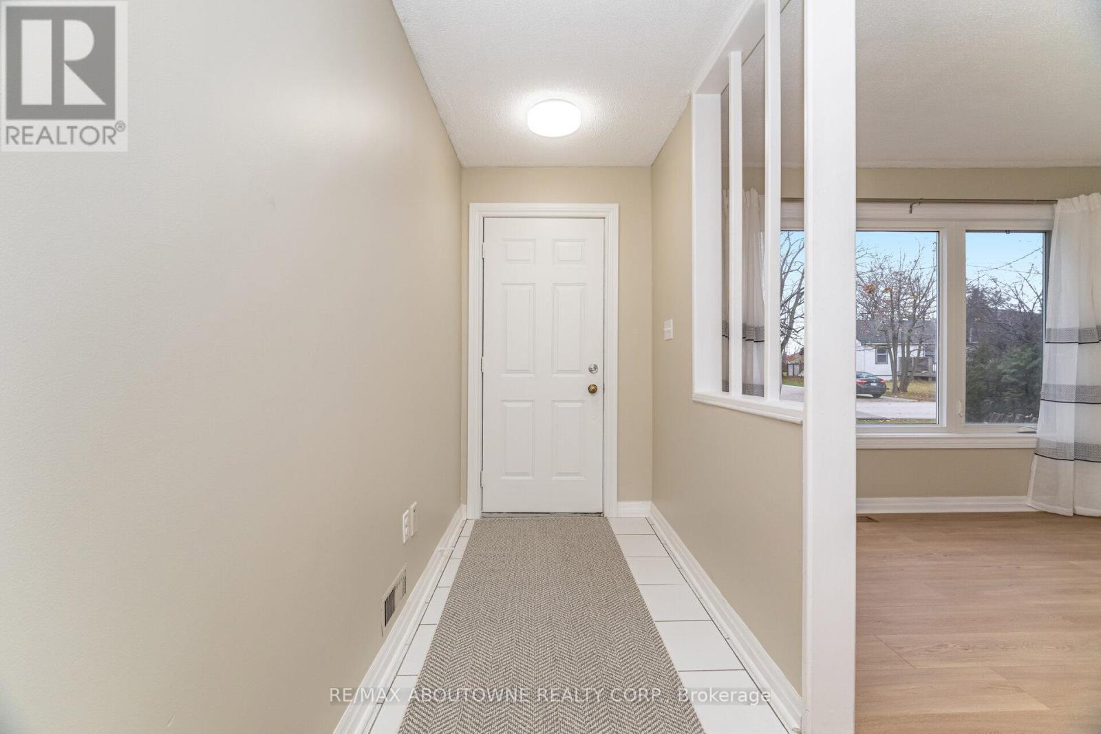 A hallway with a door and a window.