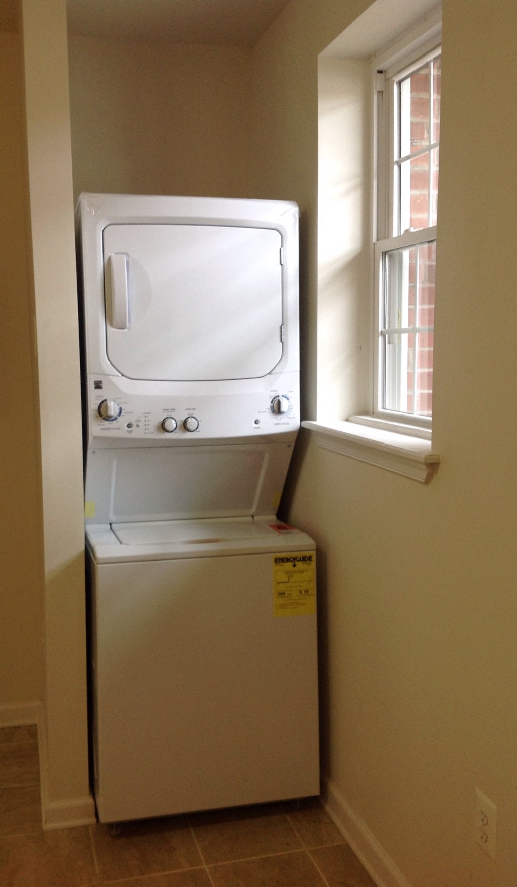 a dryer and a window in a small room