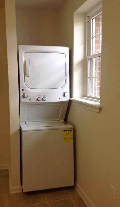 a dryer and a window in a small room