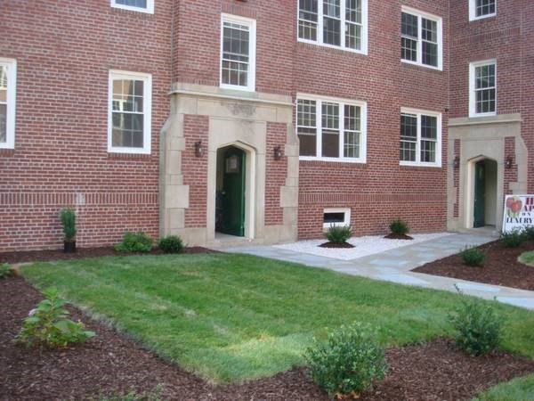 a brick building with a lawn in front of it
