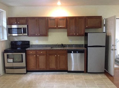a kitchen with stainless steel appliances and wooden cabinets