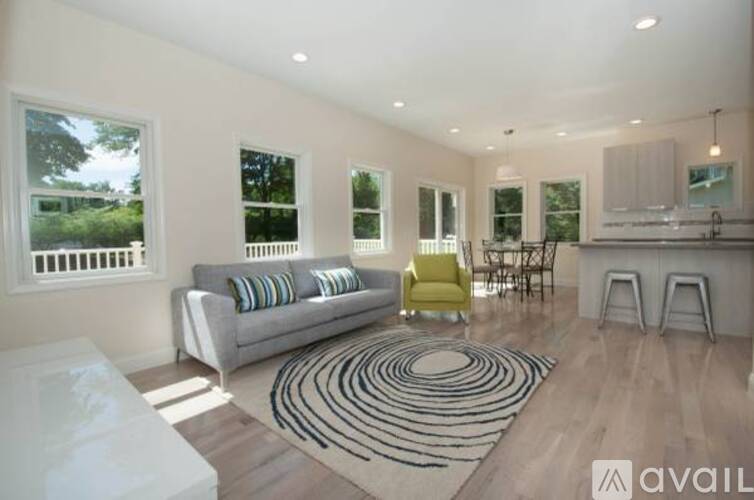 A living room with a grey couch and a yellow chair.