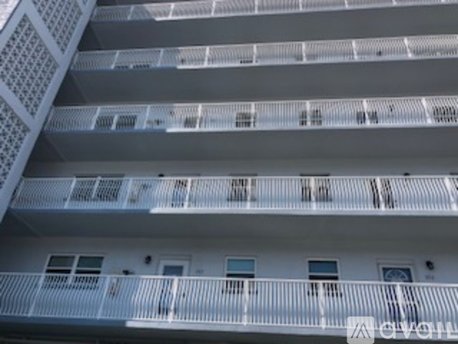 A white building with balconies and windows.