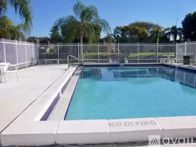 A pool with a white fence and a sign that says "NO DIVING".