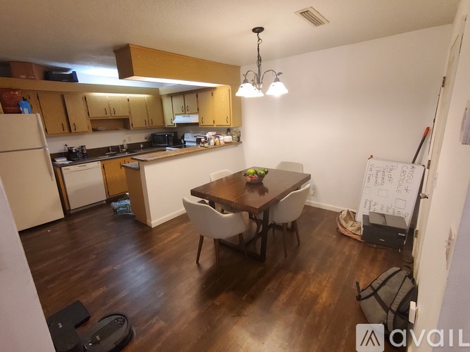 A kitchen with a dining table and chairs in the middle of the room.