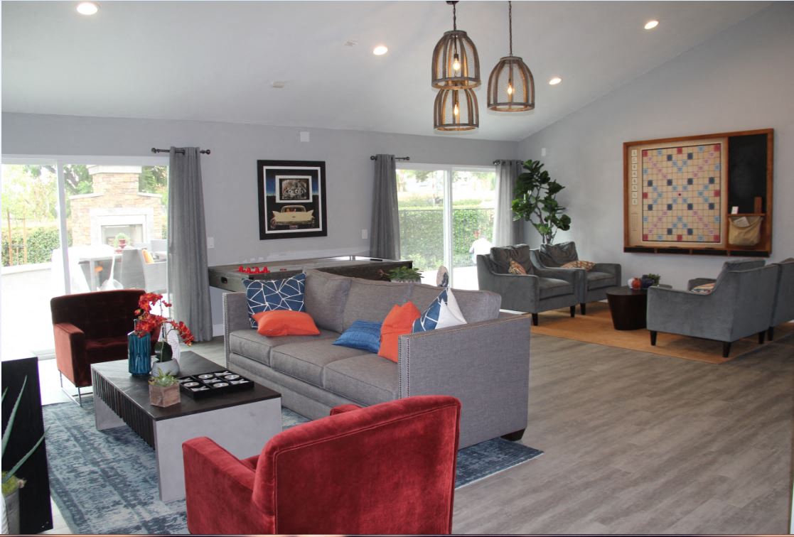 a living room with couches and chairs and a tv