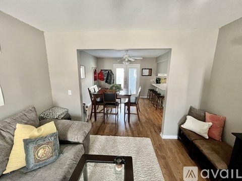 A living room with a grey couch and a coffee table in the middle.