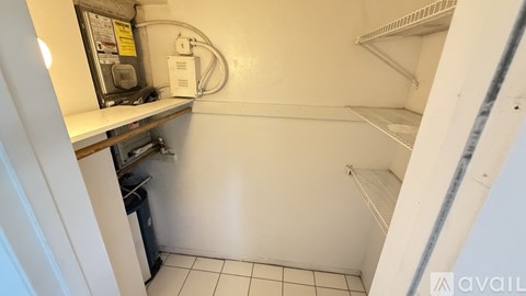 A kitchen with white cabinets and a wooden floor.