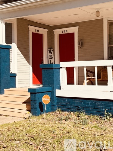 A house with a red door and a blue pillar.