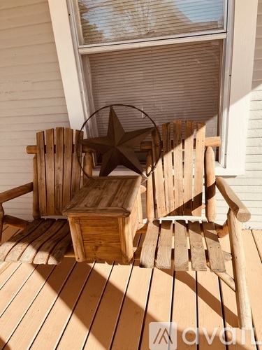 A wooden chair and table on a deck with a star decoration.