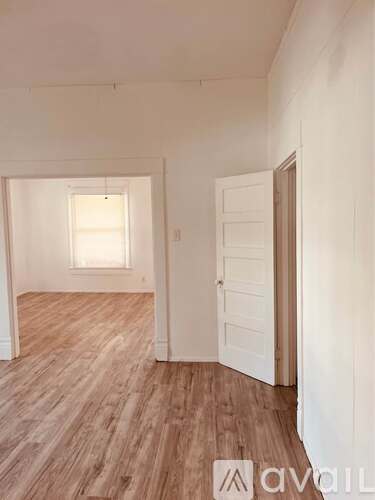 A room with wooden floors and a white door.
