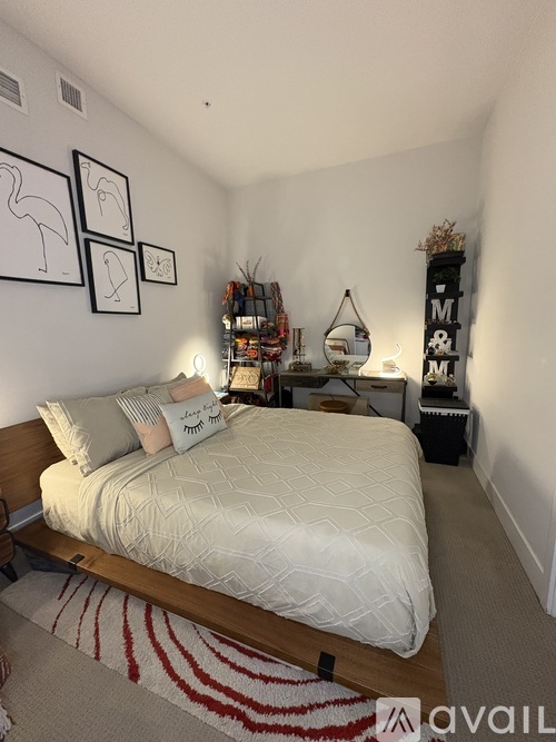 A bedroom with a bed, a nightstand, and a shelf with various items.