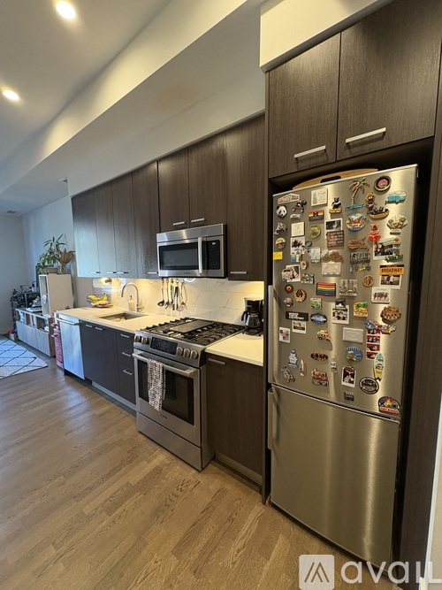 A kitchen with a refrigerator covered in magnets.