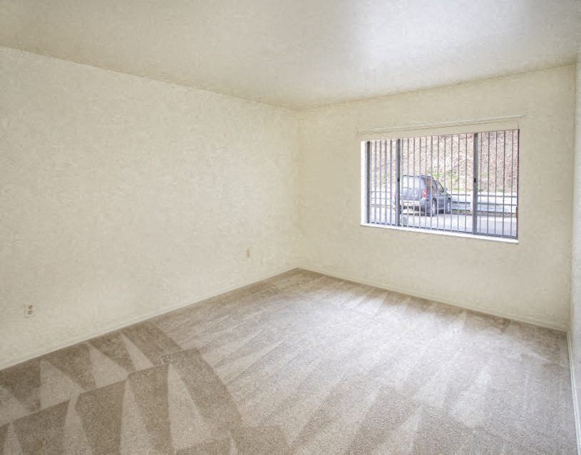 an empty living room with a large window